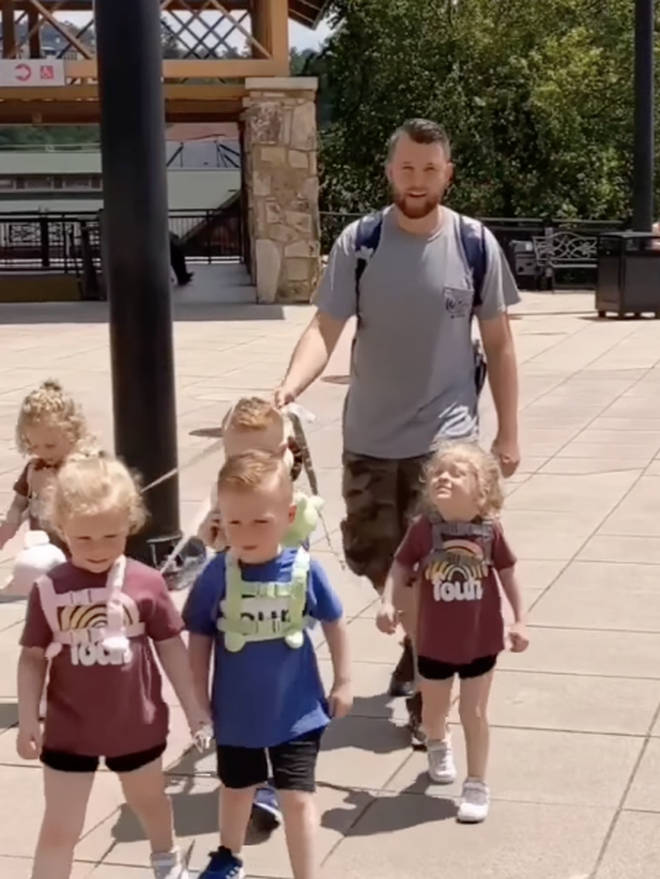 Jordan Driskell uses the leash to keep his children running off, which can be dangerous