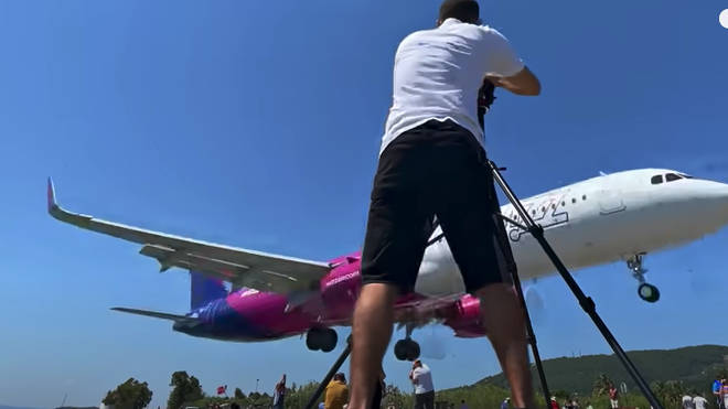 An airplane was caught landing very close to passersby