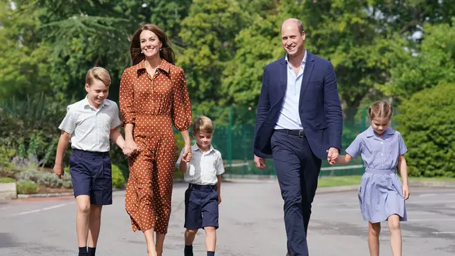 Prince William and Kate Middleton held hands with their children as they walked towards the school