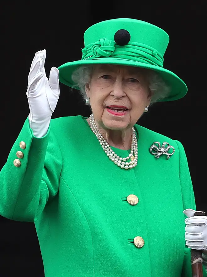 The Queen in emerald green suit