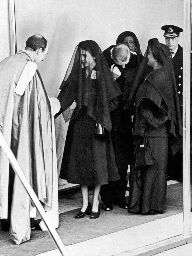 Queen Elizabeth II dresses in mourning clothing as she attends the funeral of her father, King George VI