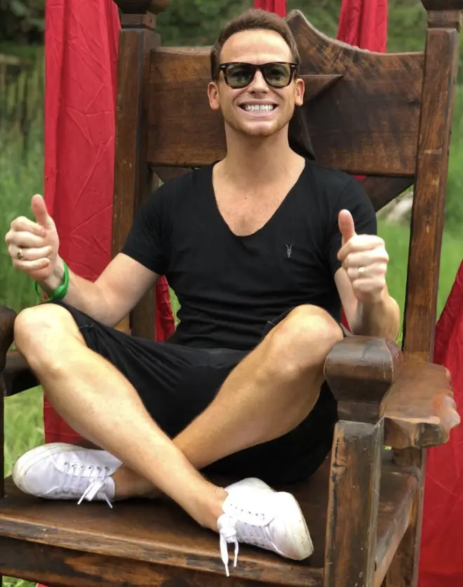 Joe Swash poses on the throne in Australia while presenting I'm A Celeb: Extra Camp