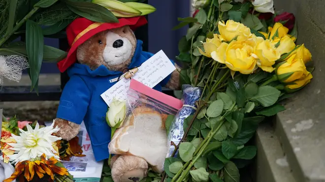 People leave Paddington Bear toys outside Buckingham Palace following the death of Queen Elizabeth II