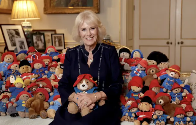 Camilla Queen Consort poses with Paddington Bear toys in the Morning Room of Clarence House