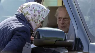 Prince Philip pictured in his Land Rover speaking to the Queen