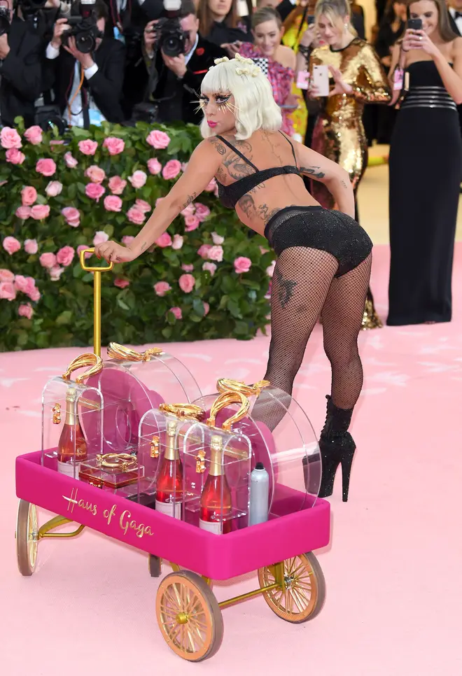 To complete Lady Gaga's Met Gala outfits, she wore a black bra, hot pants and fishnets