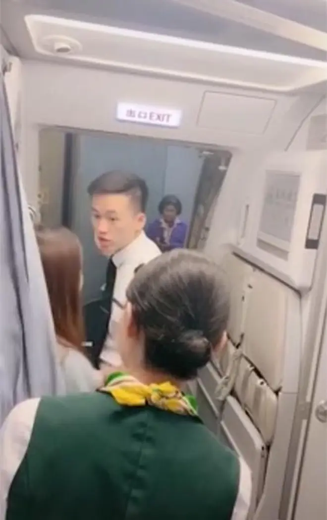 The plan e was delayed after a woman allegedly stopped cabin crew from shutting the doors