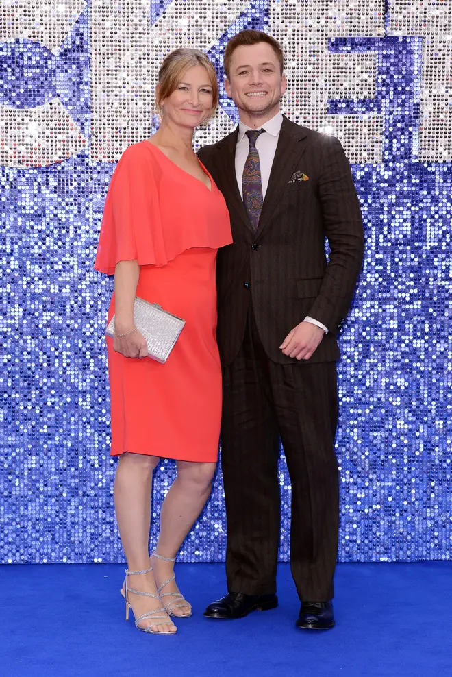 Taron also posed with his mum, Christine, on the blue carpet