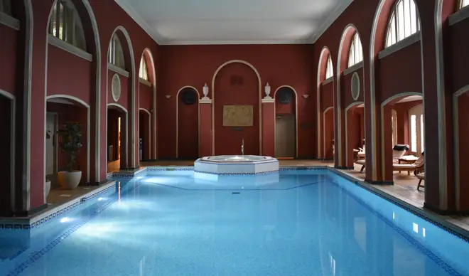 The spa features an ornate swimming pool complete with statues
