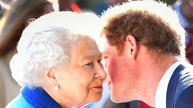 Prince Harry gives his grandmother, Queen Elizabeth II, a kiss as they attend the Chelsea Royal Flower Show together in 2015