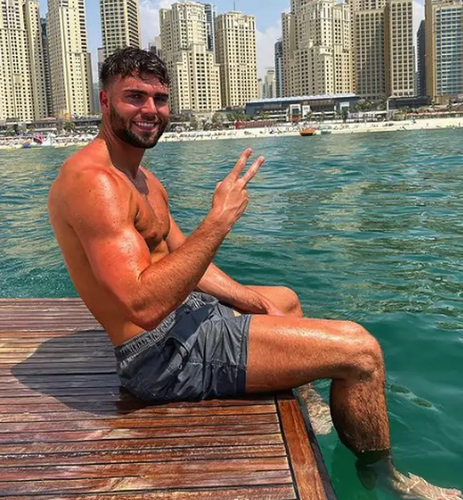 Love Island Tom Clare sitting by the pool on holiday