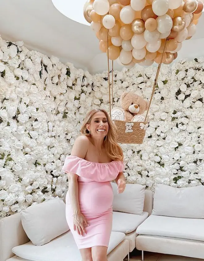 Stacey Solomon poses in a pink dress as her sister throws her a baby shower