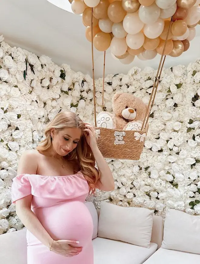 Stacey Solomon cradles her baby bump at her baby shower