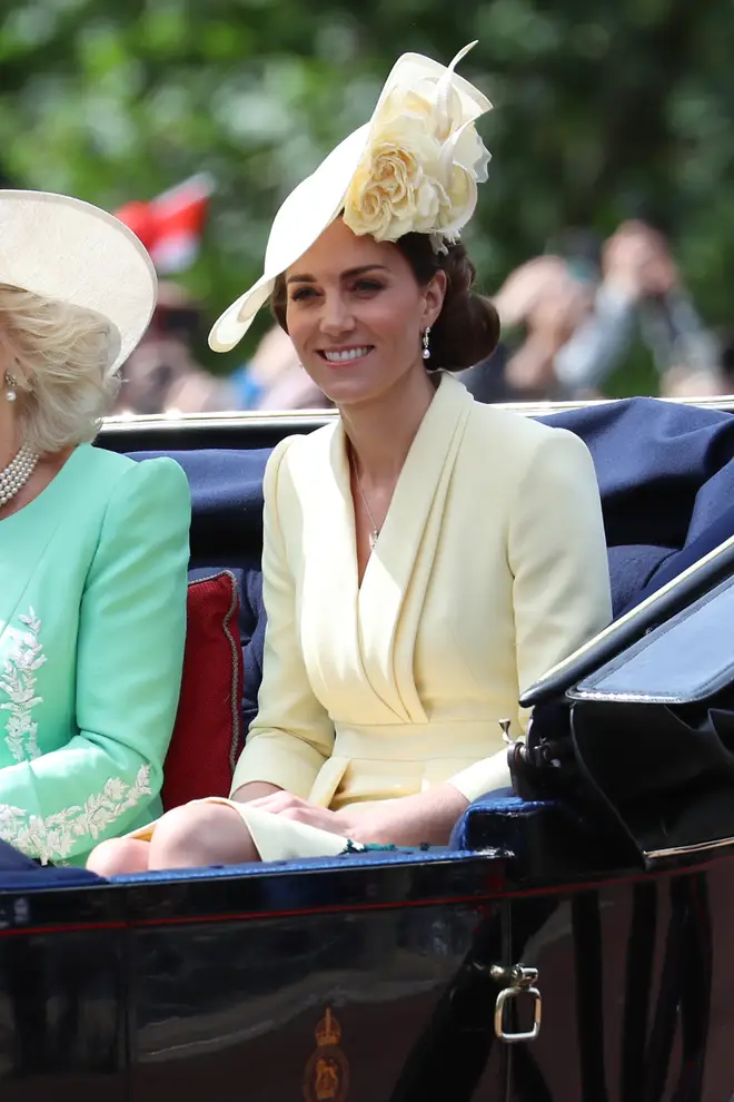 Kate Middleton looked polished in a lemon yellow coat dress and hat.