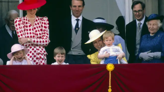 Princess Anne holding Prince Harry.