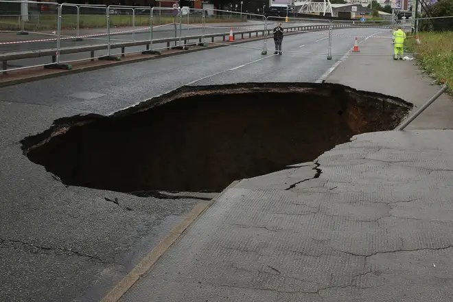 What are sinkholes and what causes them to form?