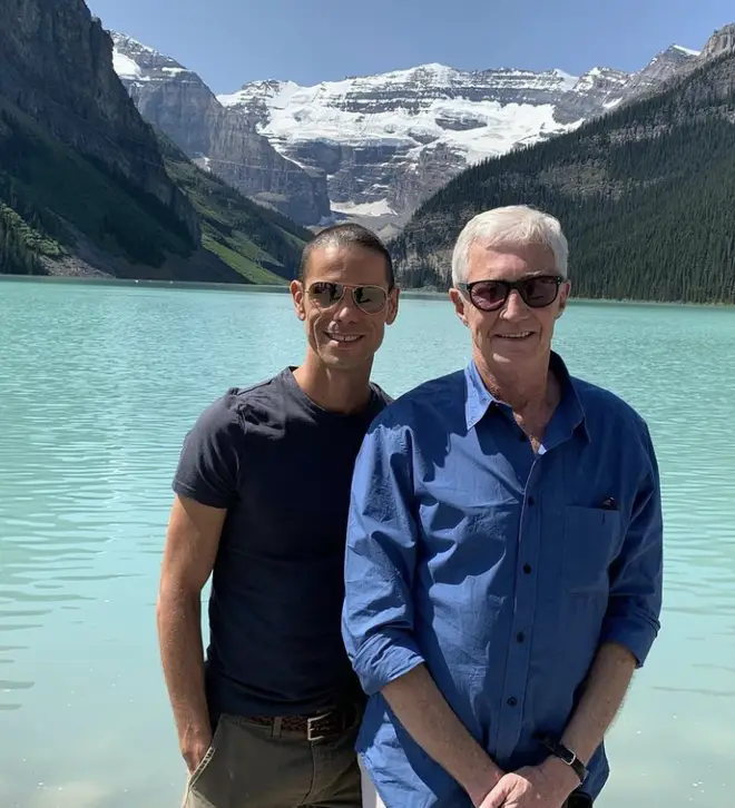 Paul O'Grady and Andre Portasio pose together during a holiday together