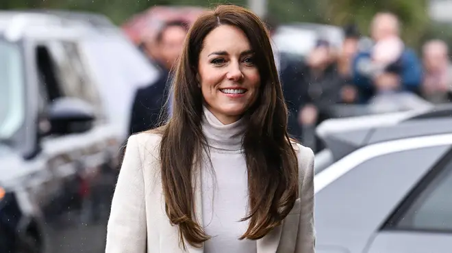 Kate Middleton wearing her hair straight in a cream top and blazer