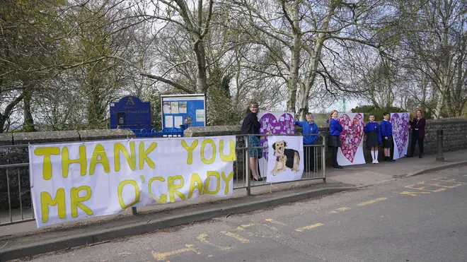 Pupils and teachers from Aldington Primary School pay their respects to Paul O'Grady