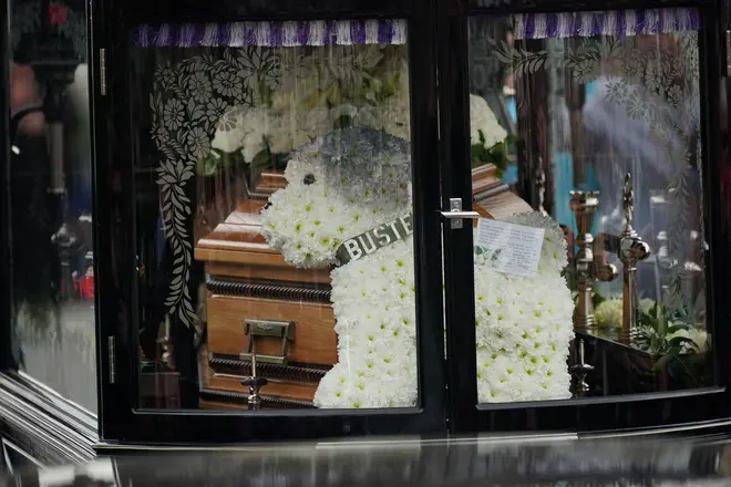 A flower arrangement in the shape of Paul's late dog, Buster, could be seen in the hearse carrying Paul's coffin