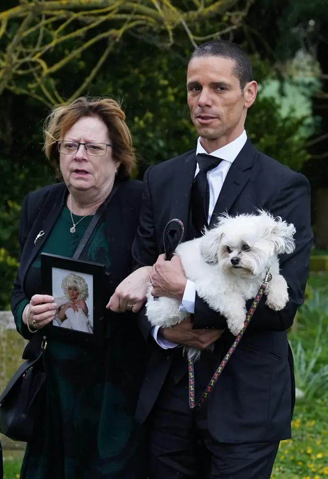 Paul O'Grady's husband Andre Portasio carried their dog Conchita into the church for the funeral