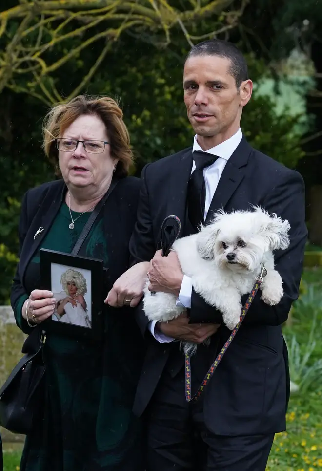 Paul O'Grady's husband Andre Portasio carried their dog Conchita into the church at his funeral 