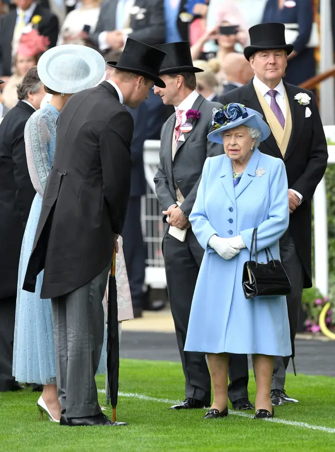 Dressed in an identical shade, the Queen covered up from the rain in a sky blue coat, with matching hat