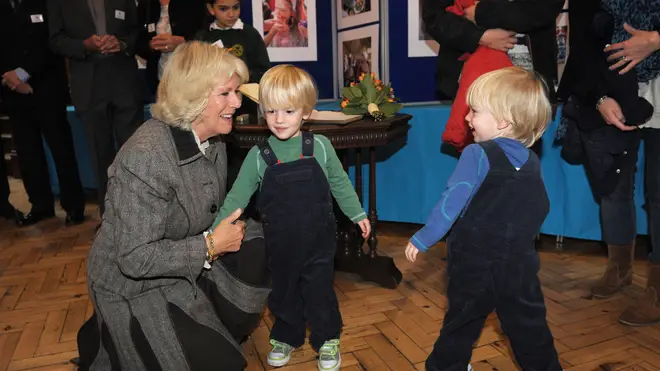 Queen Camilla is pictured with Gus and Louis Lopes as she visits Marlborough, 2012