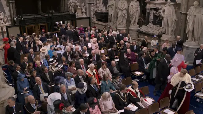 Guests attending the Coronation take their seats in Westminster Abbey