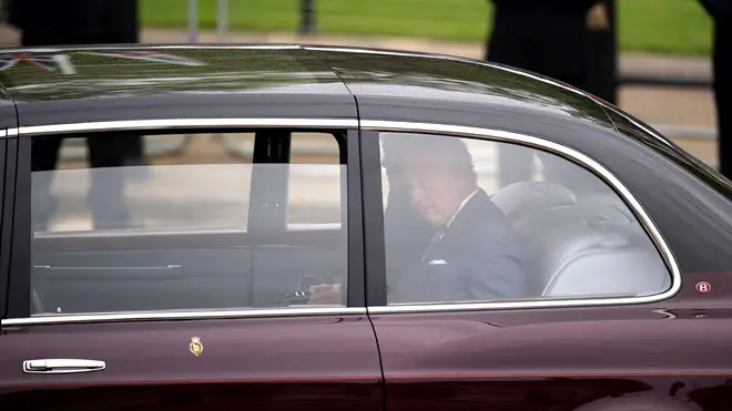 King Charles III and Queen Camilla arrive by car at Buckingham Palace