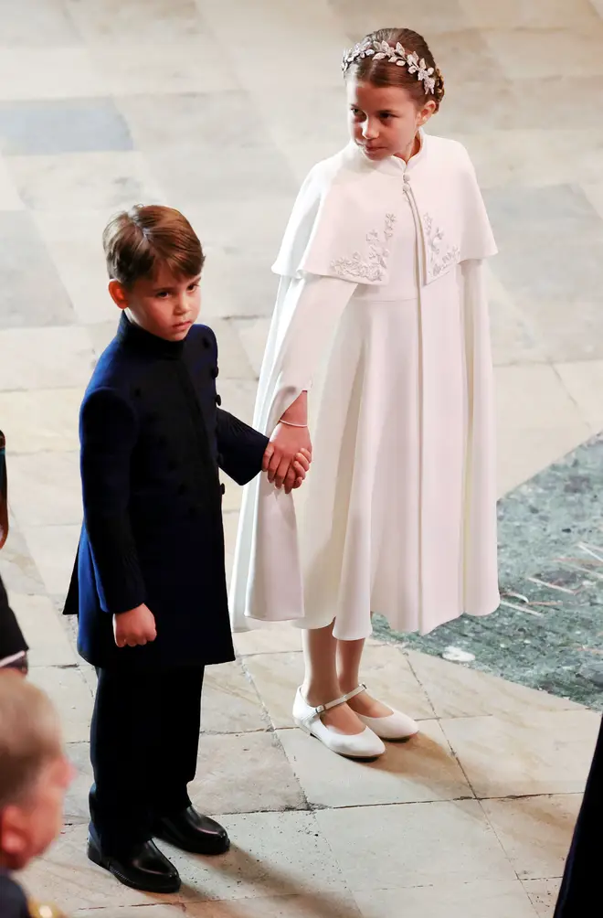 Princess Charlotte holds Princes Louis' hand as they arrive at Westminster Abbey