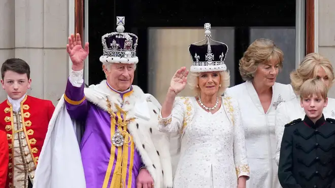 King Charles III and Queen Camilla wave to the crowds from the balcony of Buckingham Palace