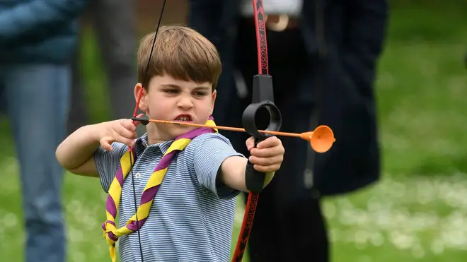 Prince Louis tries his hand at archery while taking part in the Big Help Out