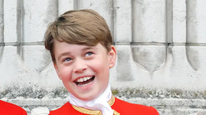 Prince George stands on the balcony of Buckingham Palace in his Page of Honour uniform