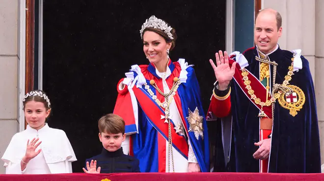 Kate Middleton, Princess Charlotte, Prince Louis and Prince William on the Buckingham Palace balcony waving on the king's coronation day