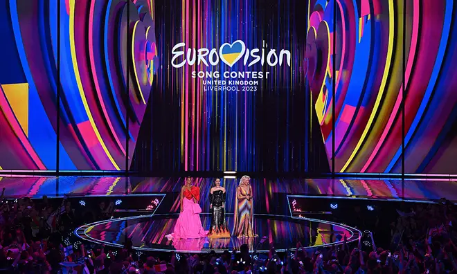 Alesha Dixon and two other Eurovision hosts on stage presenting the semi-finals