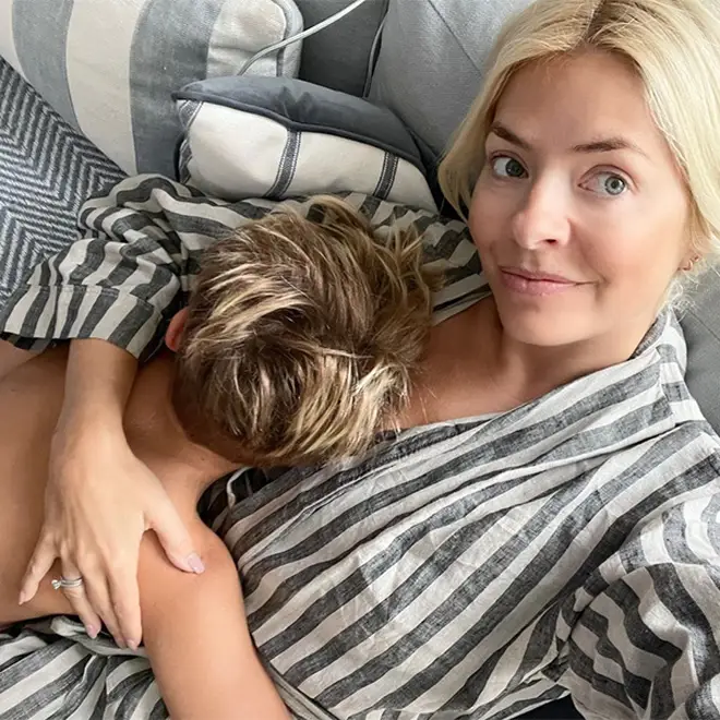 Holly Willoughby cuddling her son at home wearing stripey pyjammas