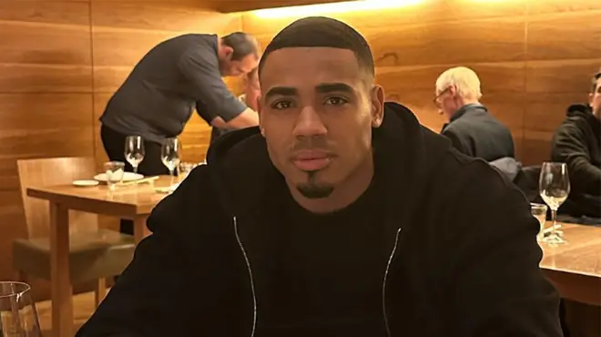 Tyrique Hyde sitting in a restaurant in a black hoodie