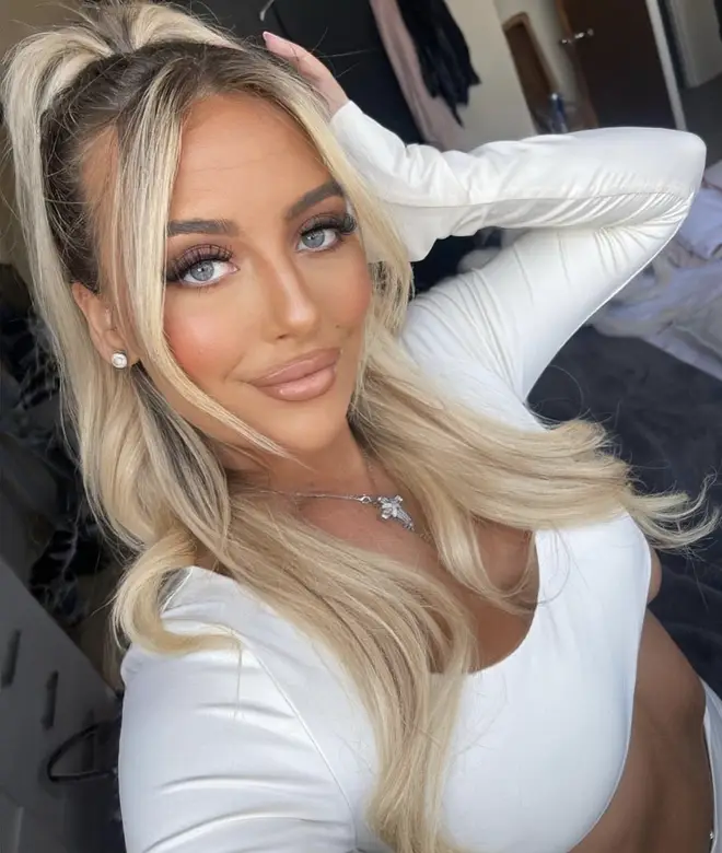 Love Island Jess wearing her hair half up and down in a white crop top