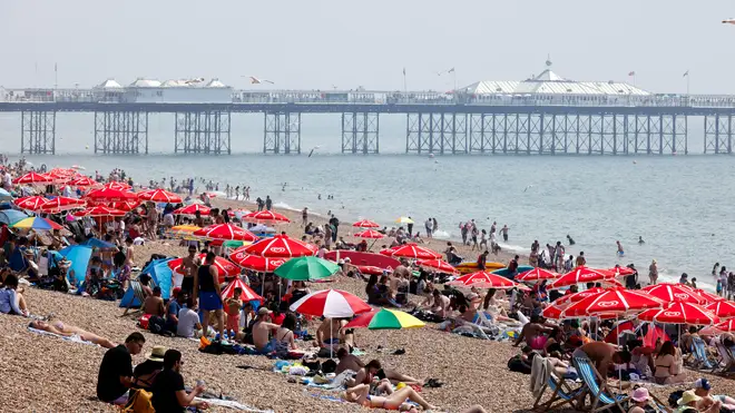 Sun-lovers flock to Brighton Beach to enjoy the heat over the weekend