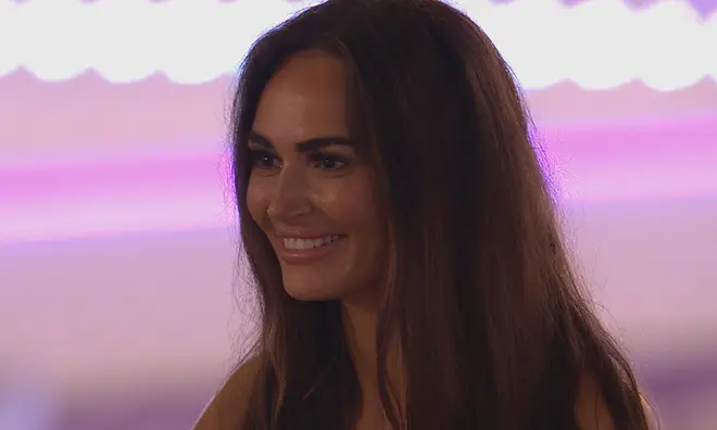 Love Island's Charlotte with her brown hair down and smiling as she entered the villa