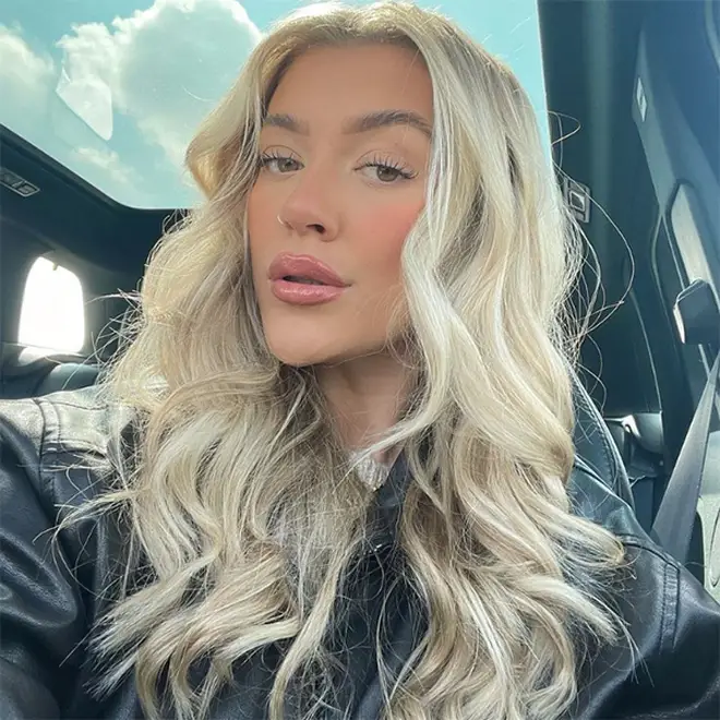 Molly Marsh taking a car selfie with her hair in beach waves