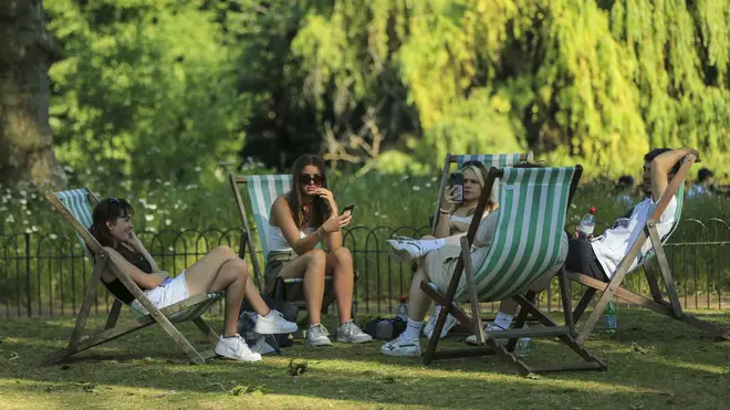 People enjoy warm weather in London