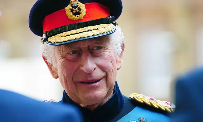 King Charles in military uniform smiling
