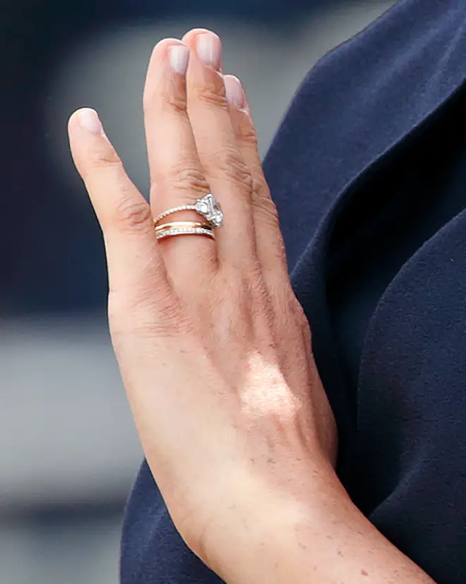 Meghan appears to have re-set the gemstones onto a thin, diamond-studded, micro-pave band.