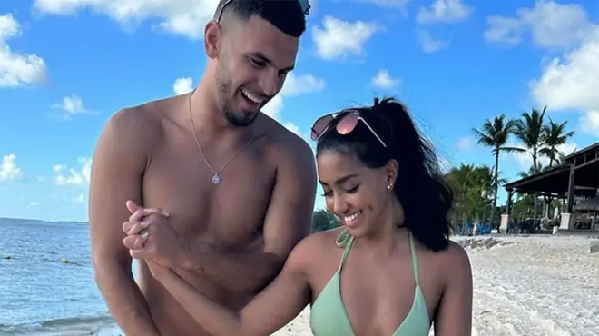 Kai Fagan and Sanam Harrinanan wearing swimwear on a Mauritius beach