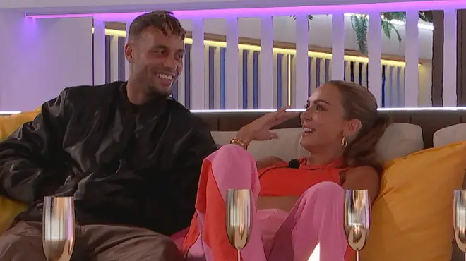 Kady McDermott and Ouzy sitting and laughing in the Love Island villa