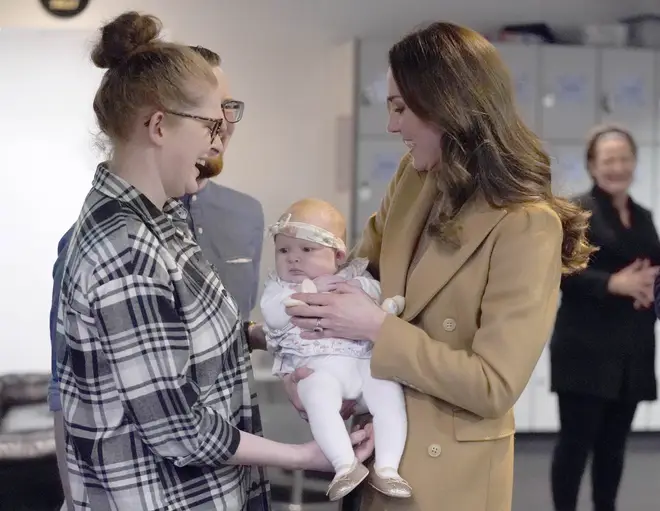Kate Middleton holds baby Anastasia during a visit to charity Church on the Street, 2022
