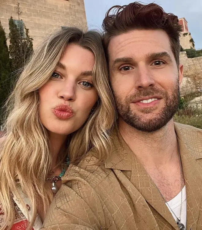 Joel Dommett and his wife Hannah Cooper pose together