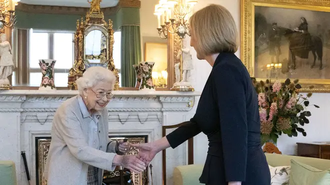Queen Elizabeth II shakes hands with Liz Truss